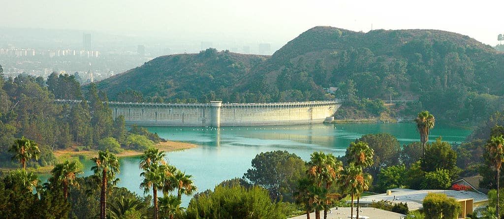A view of Hollywood Reservoir and the back side of the Mulholland Dam — viewed from Canyon Lake Drive, Los Angeles, California.