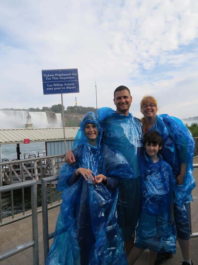A happy family wearing water cellophanes near Niagara Falls