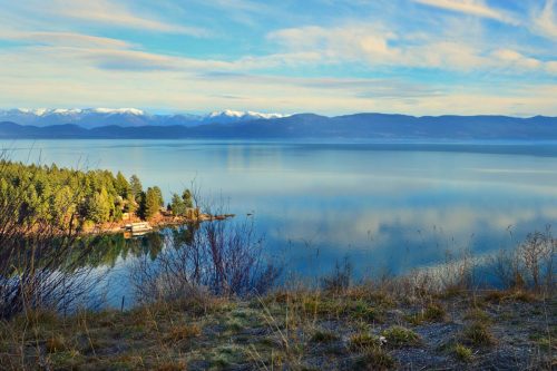 The clear waters of Flathead lake with blue mountains on the background at Montana, USA, Flathead Lake State Park, Montana - A Visitor's Guide