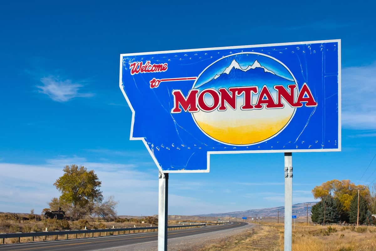 A Welcome to Montana sign on the side of the road