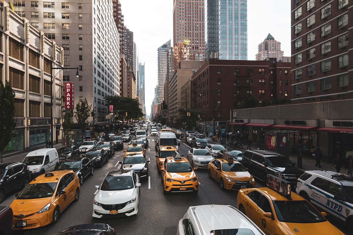 Busy street with cars and yellow taxis in Manhattan, in the large city of New York