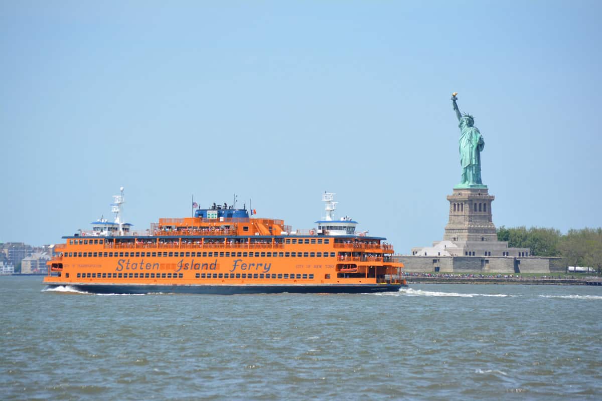 Staten Island Ferry passing the Statue of Liberty in New York Harbor - NYC Summer Bucket List [ 11 Things To Do To Feel Like a Real New Yorker]