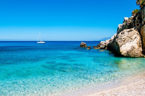 A sailing boat into the turquoise Mediterranean Sea, Can You Swim In Sicily In October? [Tips For Travel]