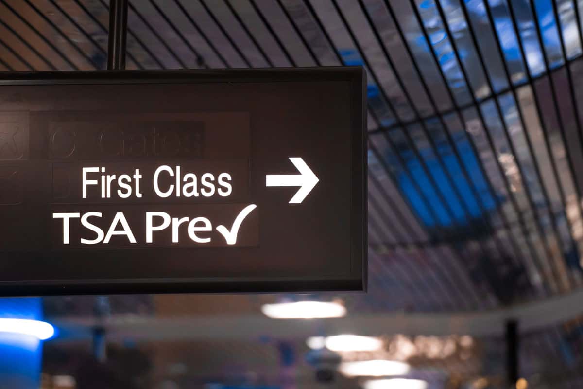 Overhead sign showing security check point lanes designated for first class and TSA Precheck passengers
