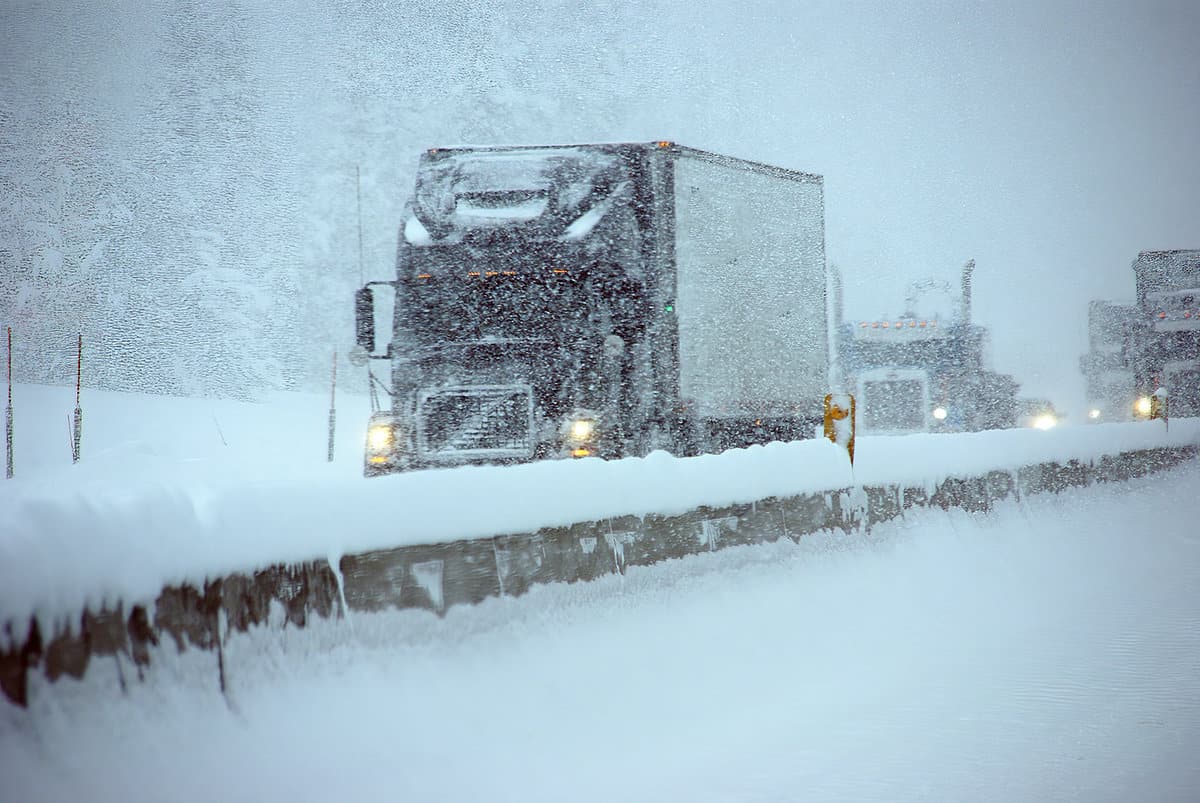 Trucks on winter highway during snowstorm, Oregon, Pacific Northwest