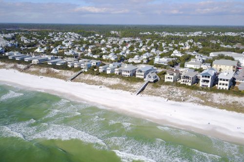 Beachfront homes in town of Seaside, Florida, seen in 4K aerial flyover from waters of Gulf of Mexico, Underrated Florida: 5 Must-See Hidden Gems To Visit