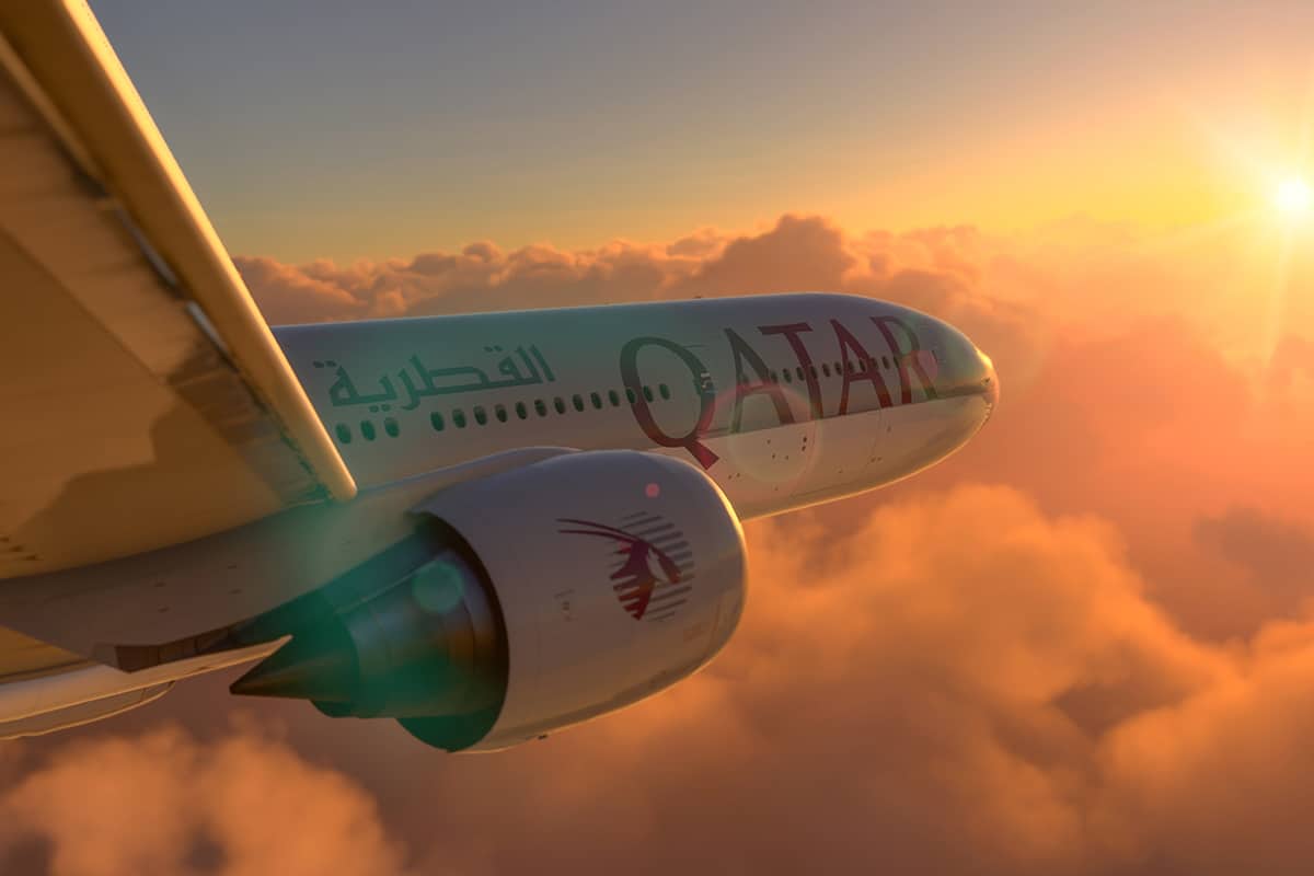 Boeing 777 Qatar Airways flying on amazing sunset