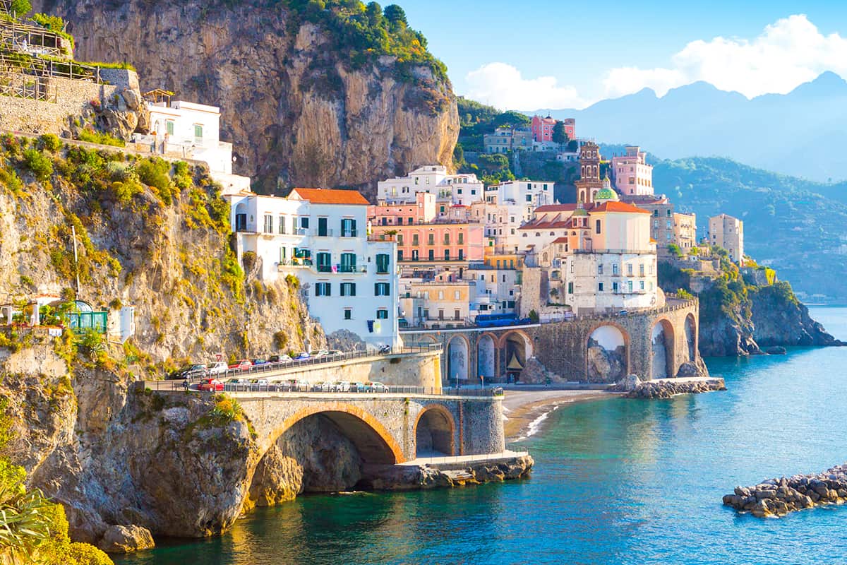 Morning view of Amalfi cityscape on coast line of mediterranean sea, How To Get To Sicily From Amalfi Coast [Tips For Travelers]