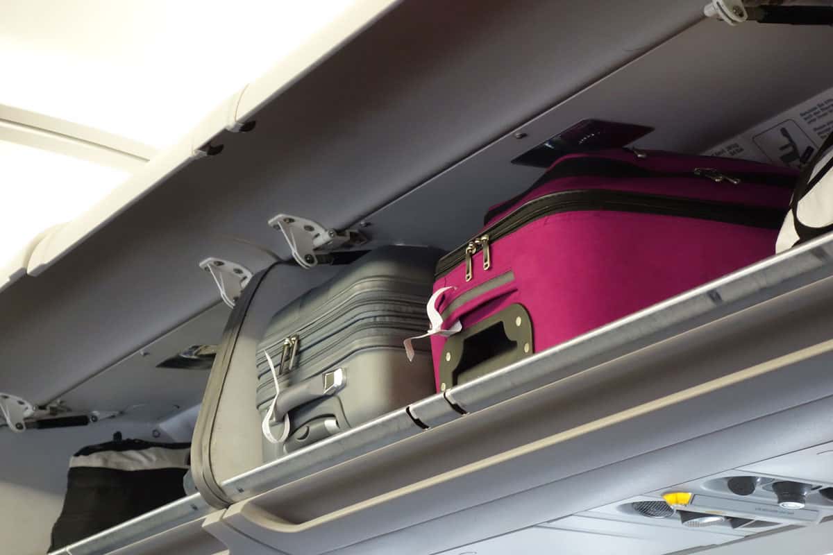 Hand-luggage compartment with hand-luggage in an airplane