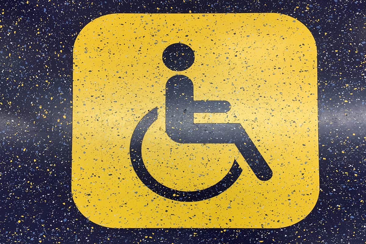A yellow wheelchair accessibility sign on the floor graphics of an R211 subway car prototype on view in New York City