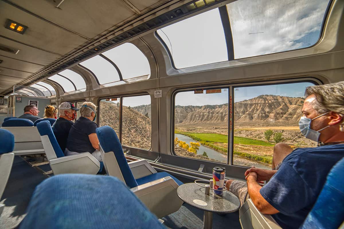 Amtrak Train crossing through the Colorado Rocky Mountains, All Aboard the Latest TikTok Craze: Riding the Rails Across America