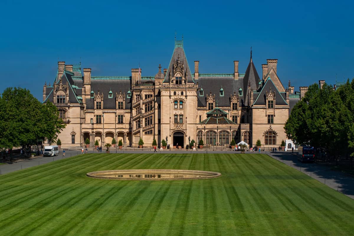 Biltmore Estate, George Vanderbilt's 250-room castle is America's Largest Home and a top attraction in Asheville with plaza in foreground, Ghostly Getaways: Uncover The Most Haunted Places Ashville, North Carolina
