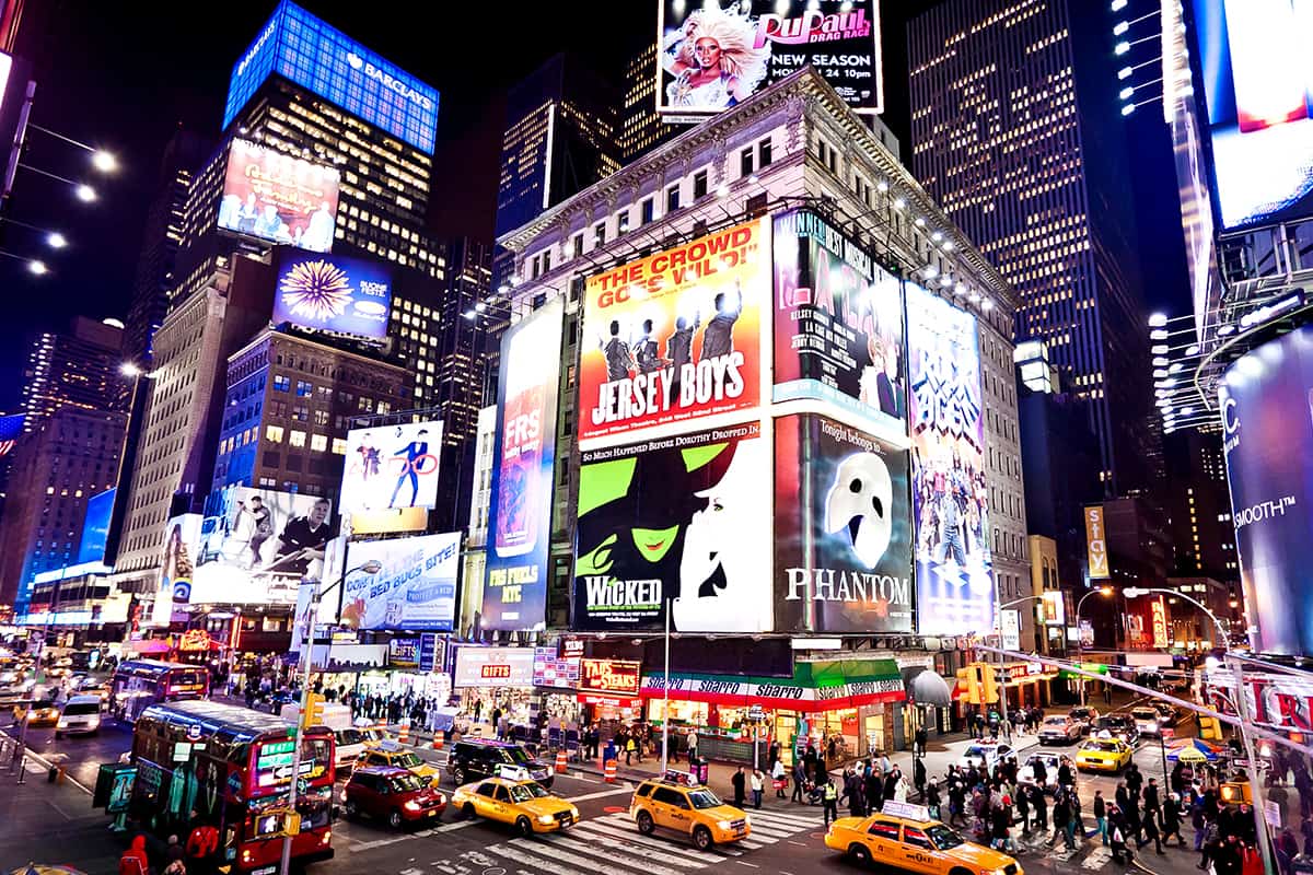Illuminated facades of Broadway theaters in Times Square, NYC
