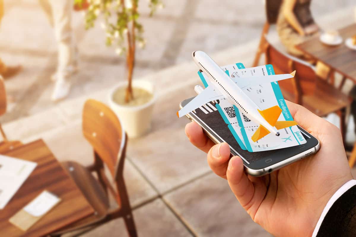 Illustration of booking a flight using an app, Click It To Book It: The Best Travel Apps for Booking Flights for 2023