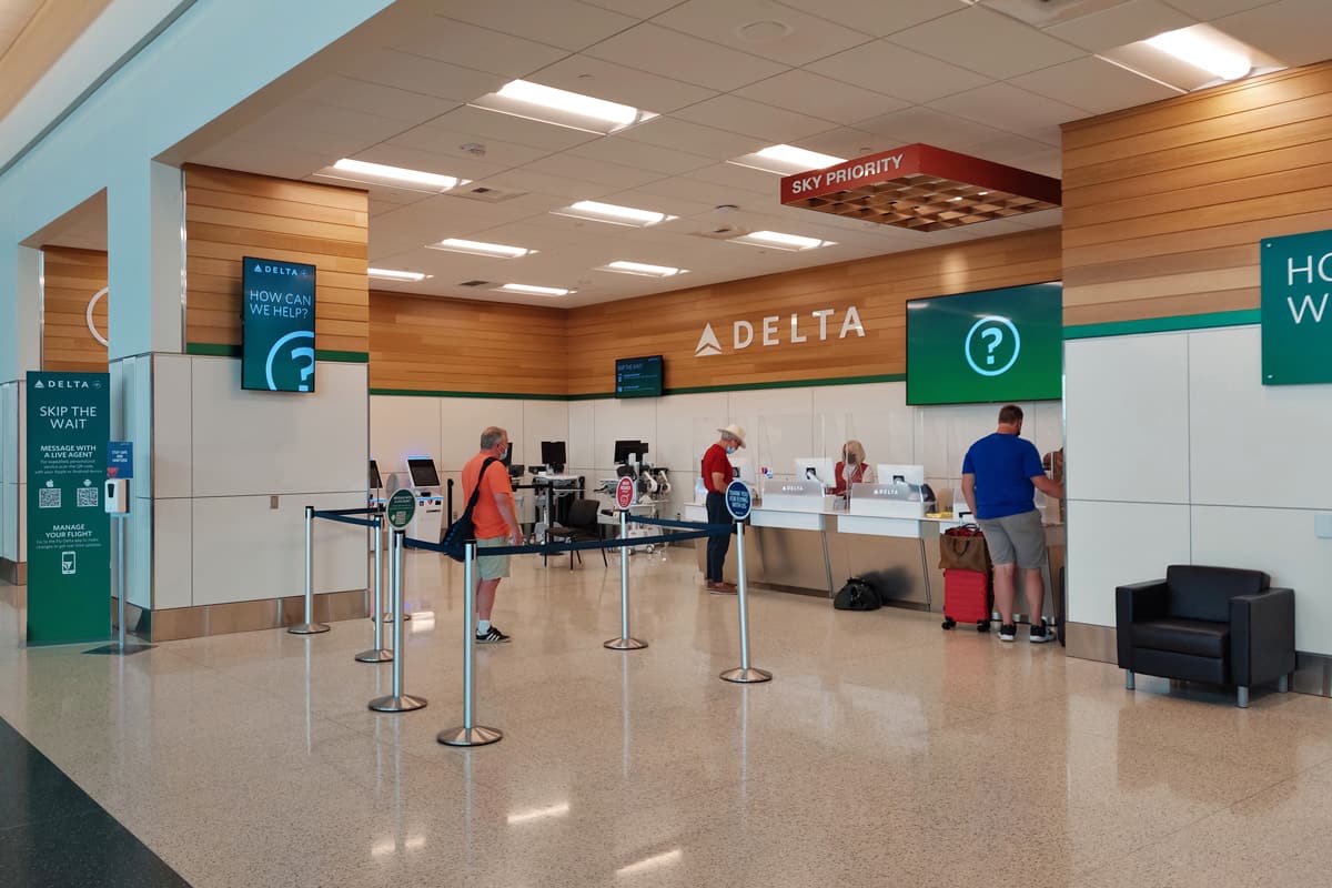 Passengers wait in line at a Delta Air Lines customer service desk at Salt Lake City Inter