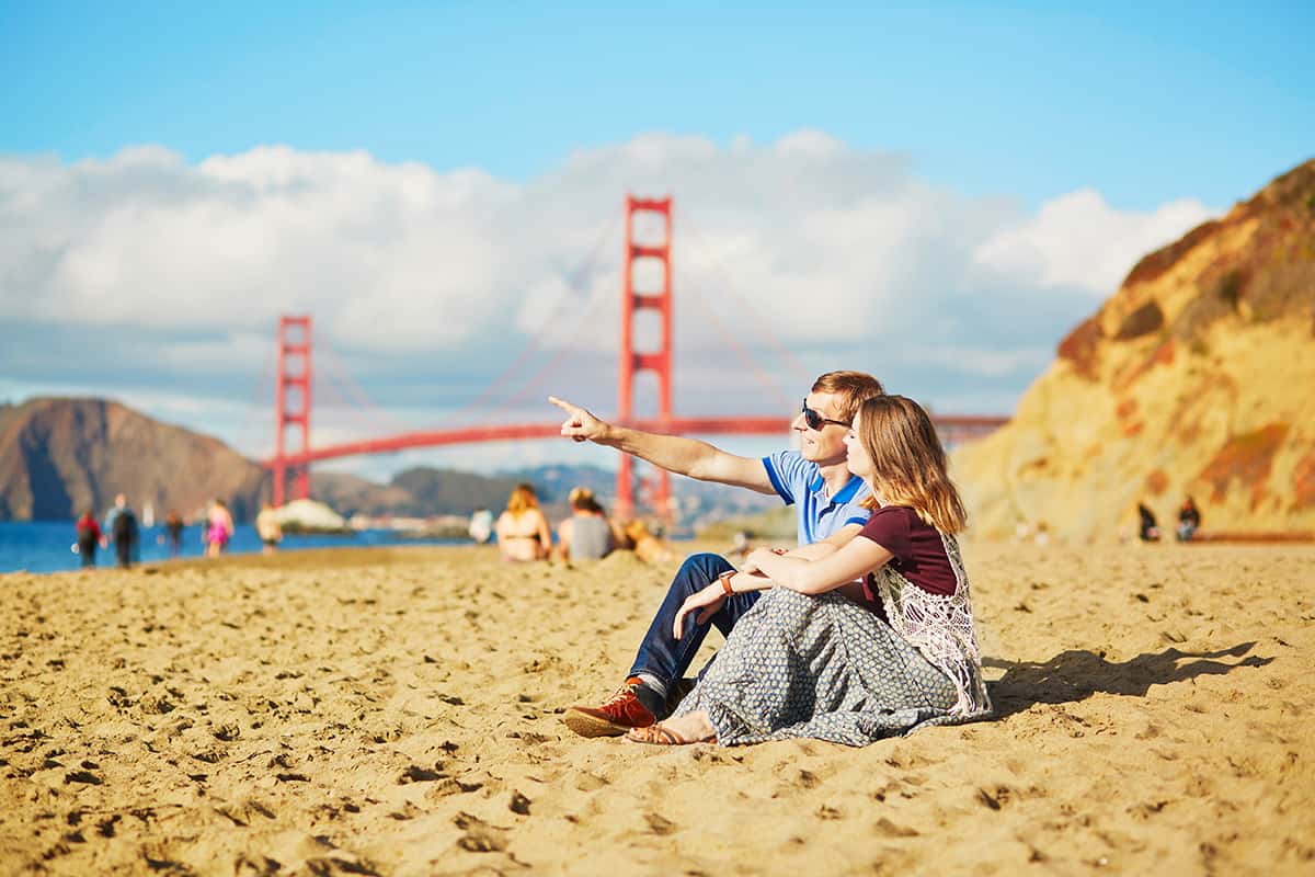 Romantic couple having a date on Baker beach in San Francisco, Romantic Date Ideas in San Francisco for Valentine's Day 2023