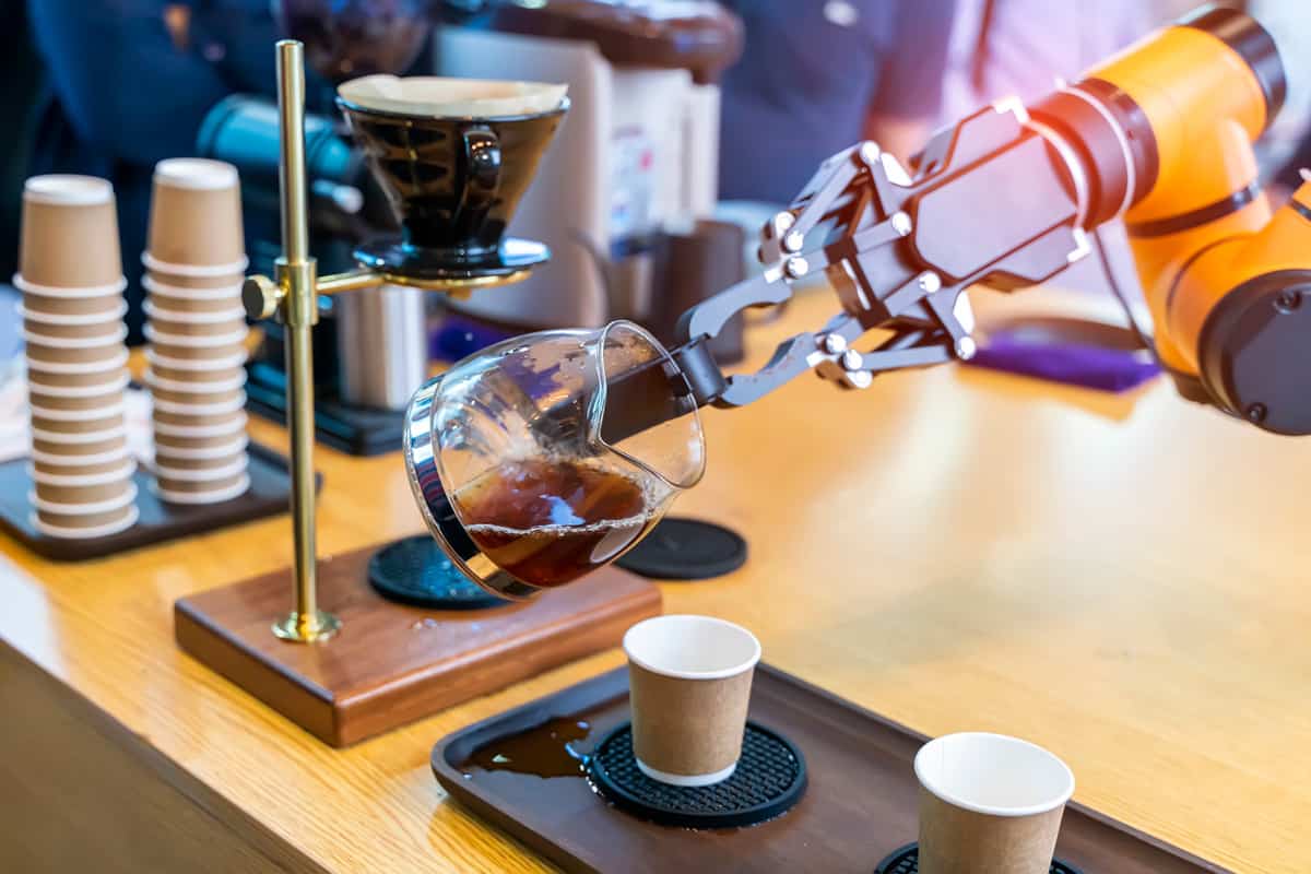 robotic arm preparing coffee in coffee machine, Say Goodbye to Baristas, And Hello To AI-Driven Latte Art