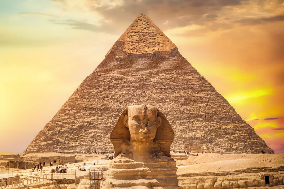 Great sphinx and pyramid under bright sun