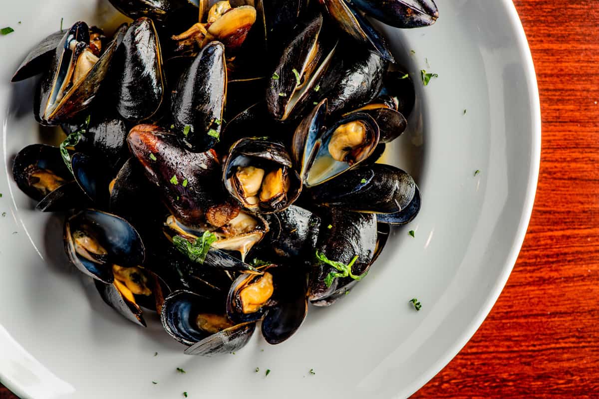 Mussels, steamed and prepared in traditional Italian preparation—in a white wine sauce, garlic, lemon juice, sh