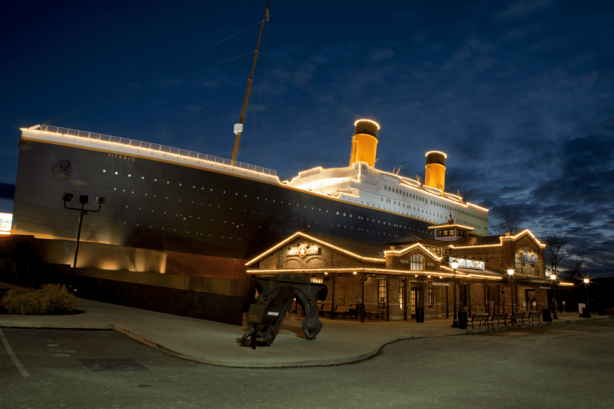 Image is the exterior of the titanic museum at night with beautiful lights.