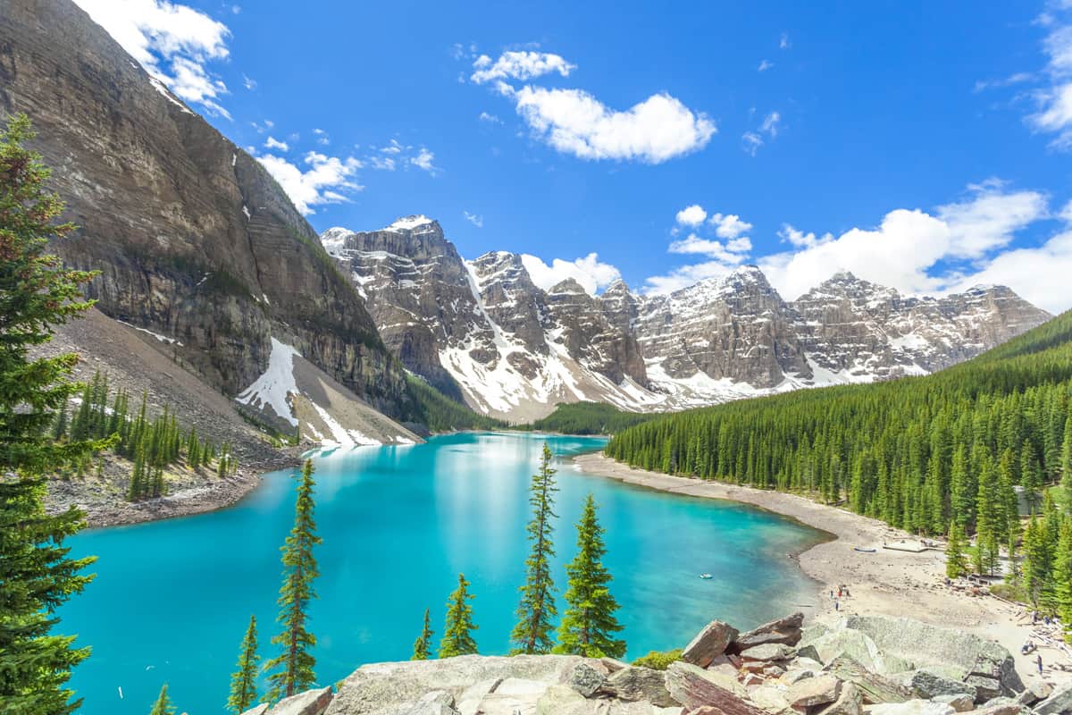 The beautiful gorgeous Turquiose waters of Lake Moraine along with the tall mountain ranges of Banff National Park, Discovering the Iconic Beauty of Moraine Lake: TikTok's Latest Obsession