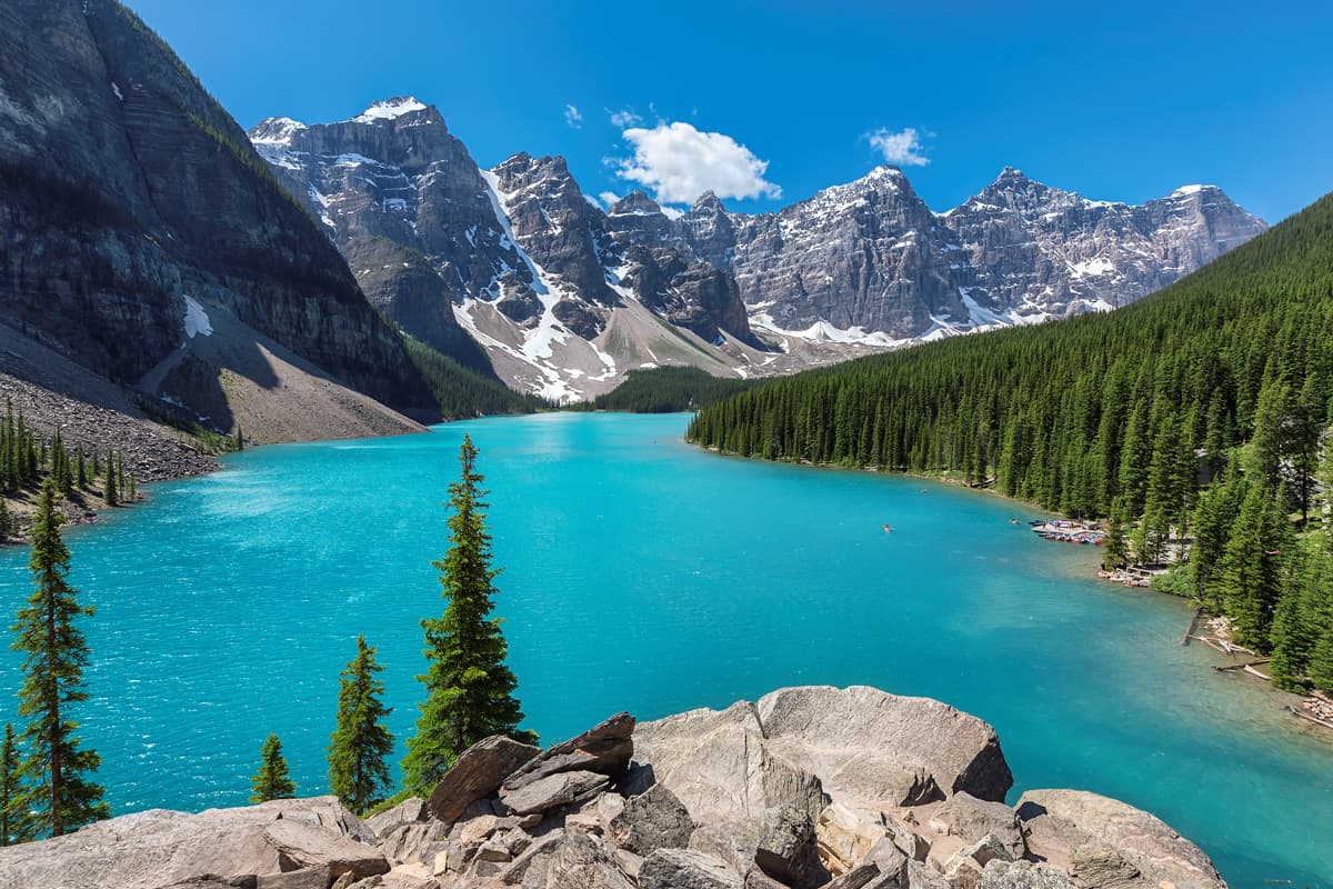 The beautiful turquoise waters of Lake Moraine surrounded by the tall rocky mountains of Banff National park