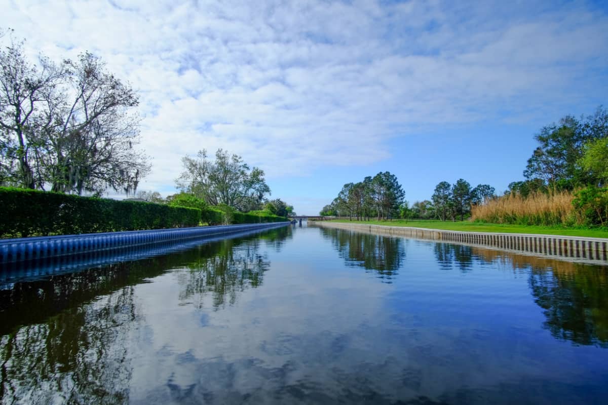 A clear canal in Winter Haven reflecting the sky