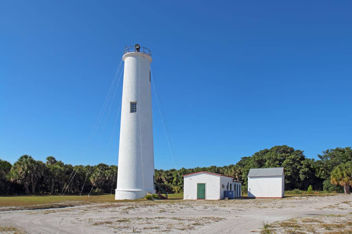 A tall white lighthouse in Egmont Key, Florida