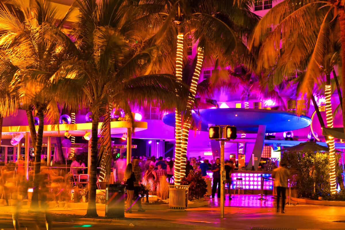 Ocean Drive scene at night lights, cars and people having fun, Miami beach
