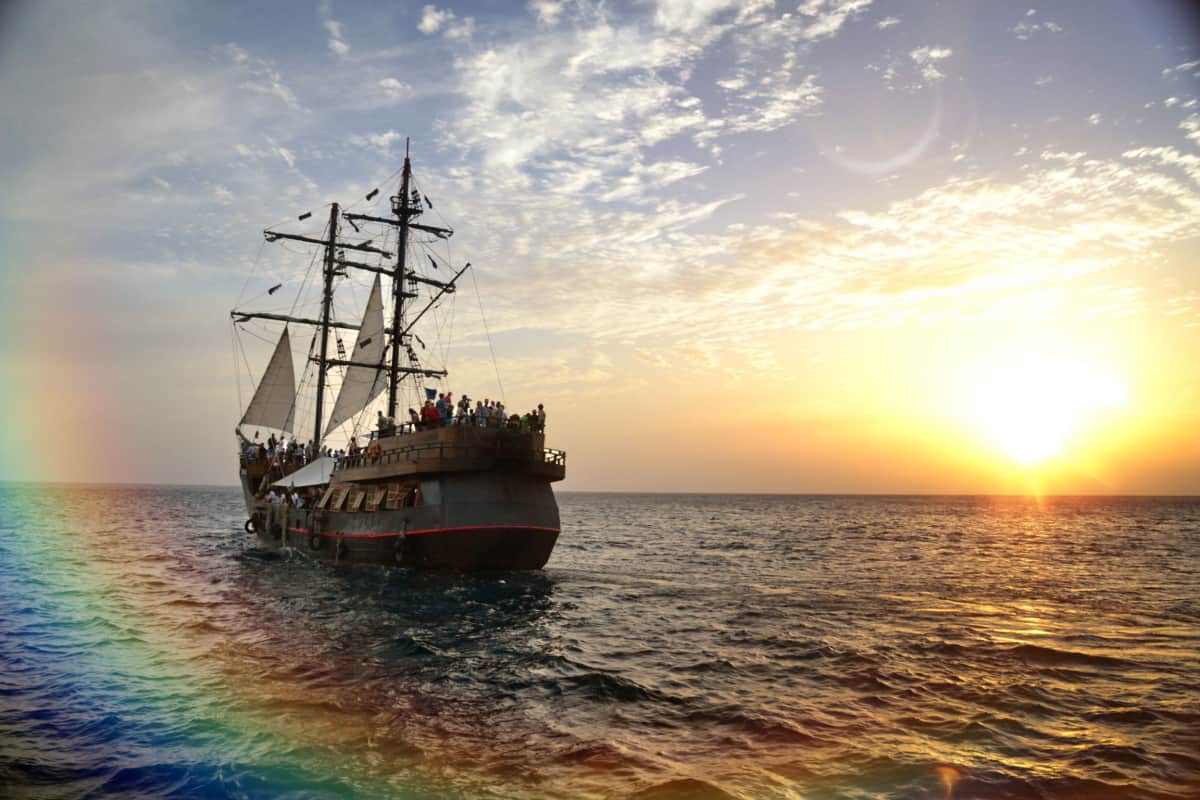 Pirate ship sailing on sunset