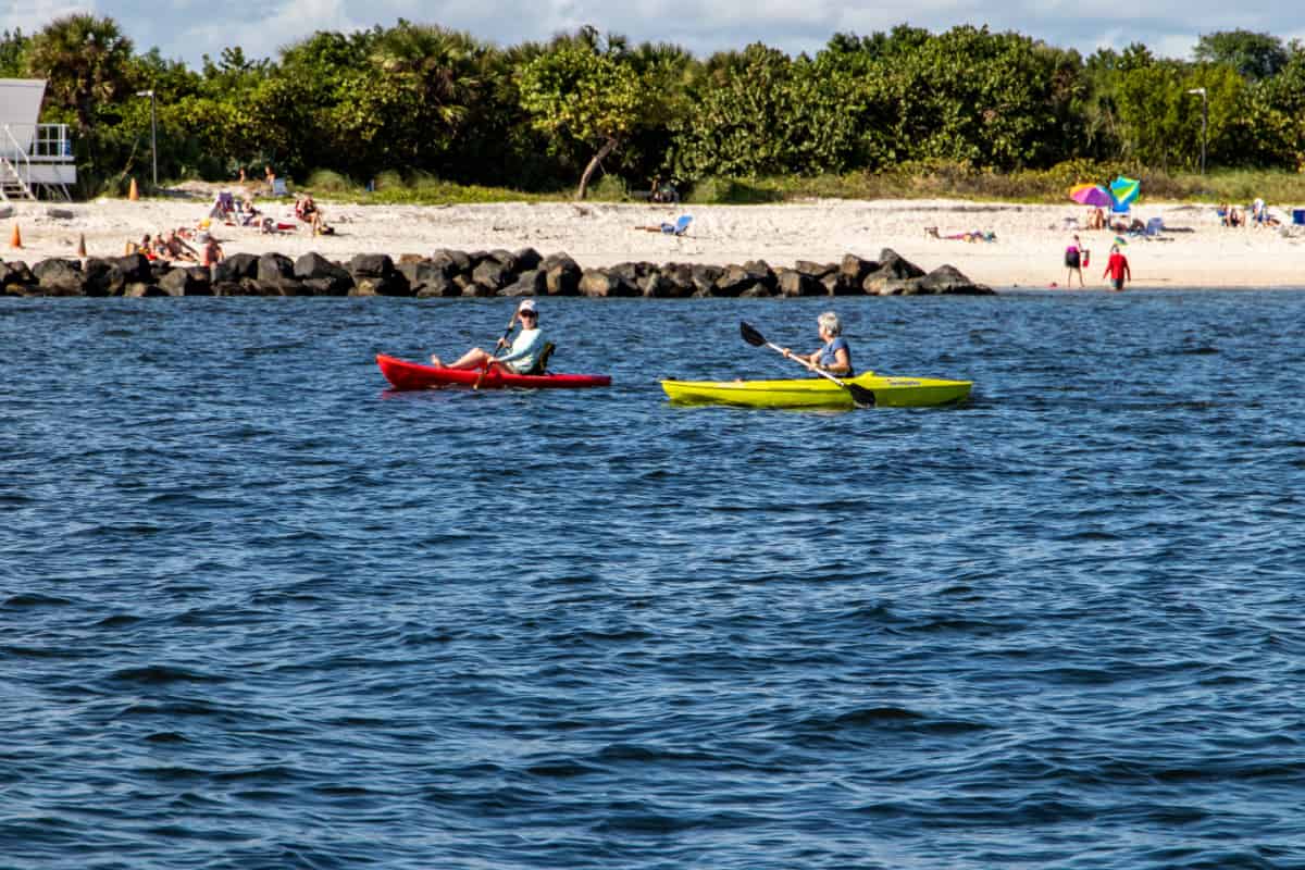 Two woman kayaking off Peanut Island