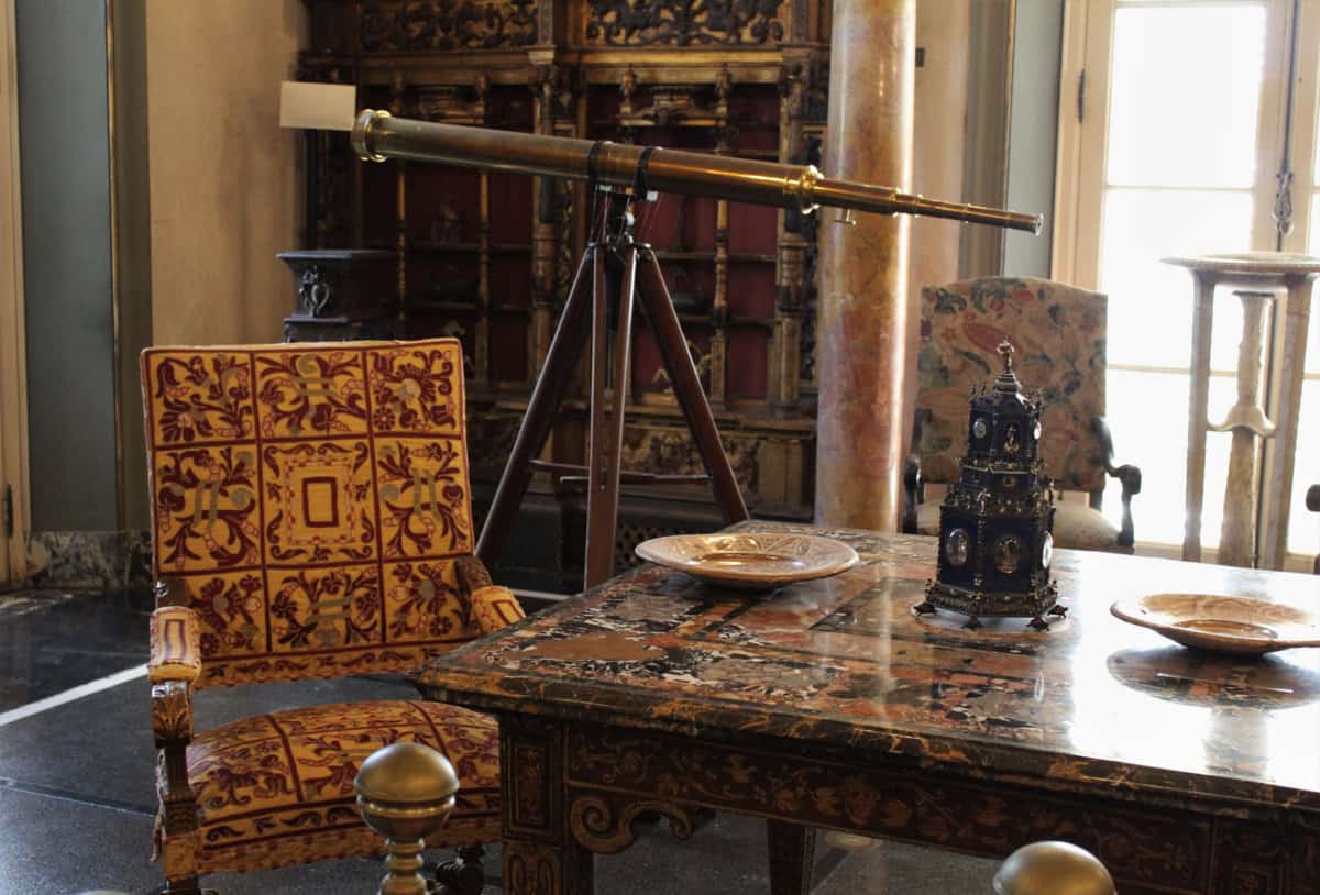 Fancy elegant room with a golden telescope seen from and antique furniture at The Vizcaya Museum and Garden