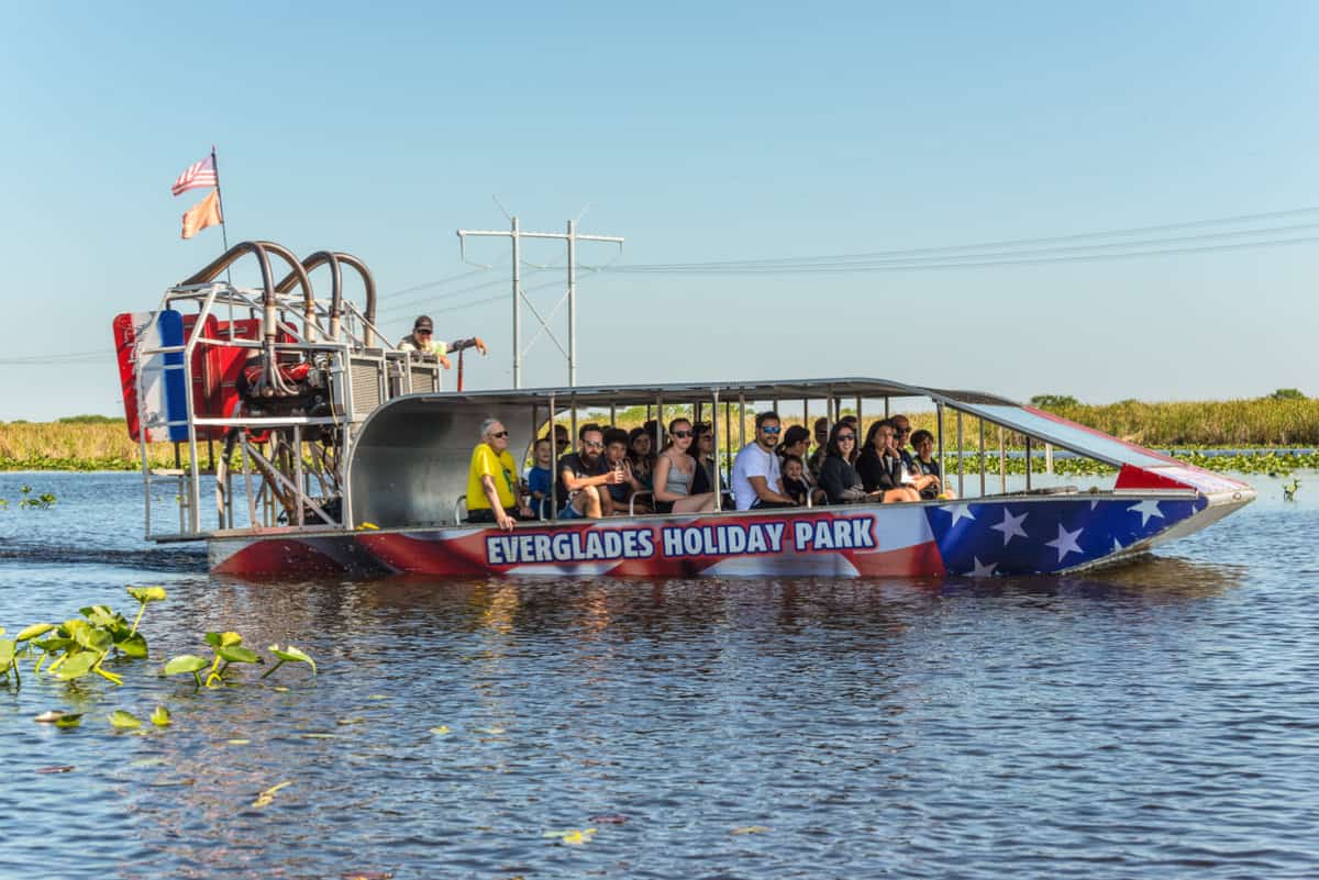 Group of tourists riding an airboat Everglades wetlands Florida