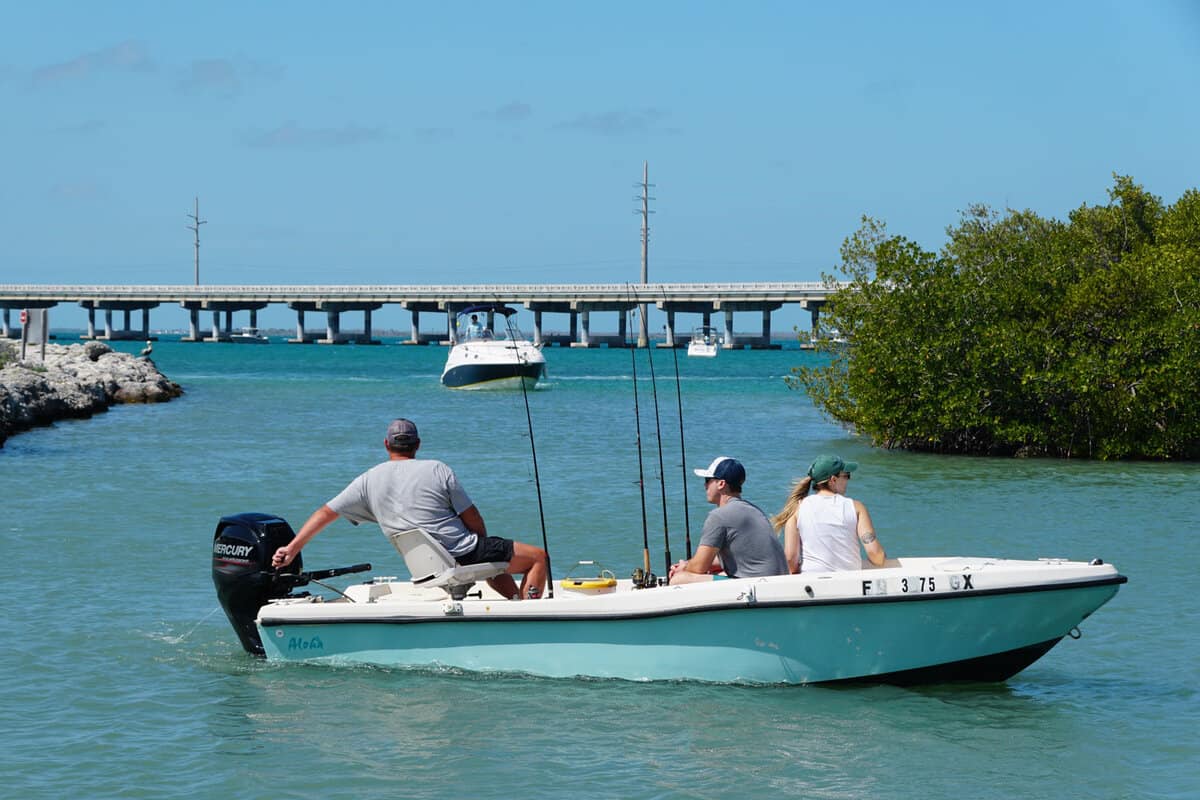 Three people in a small boat fishing at Bahia Honda state park