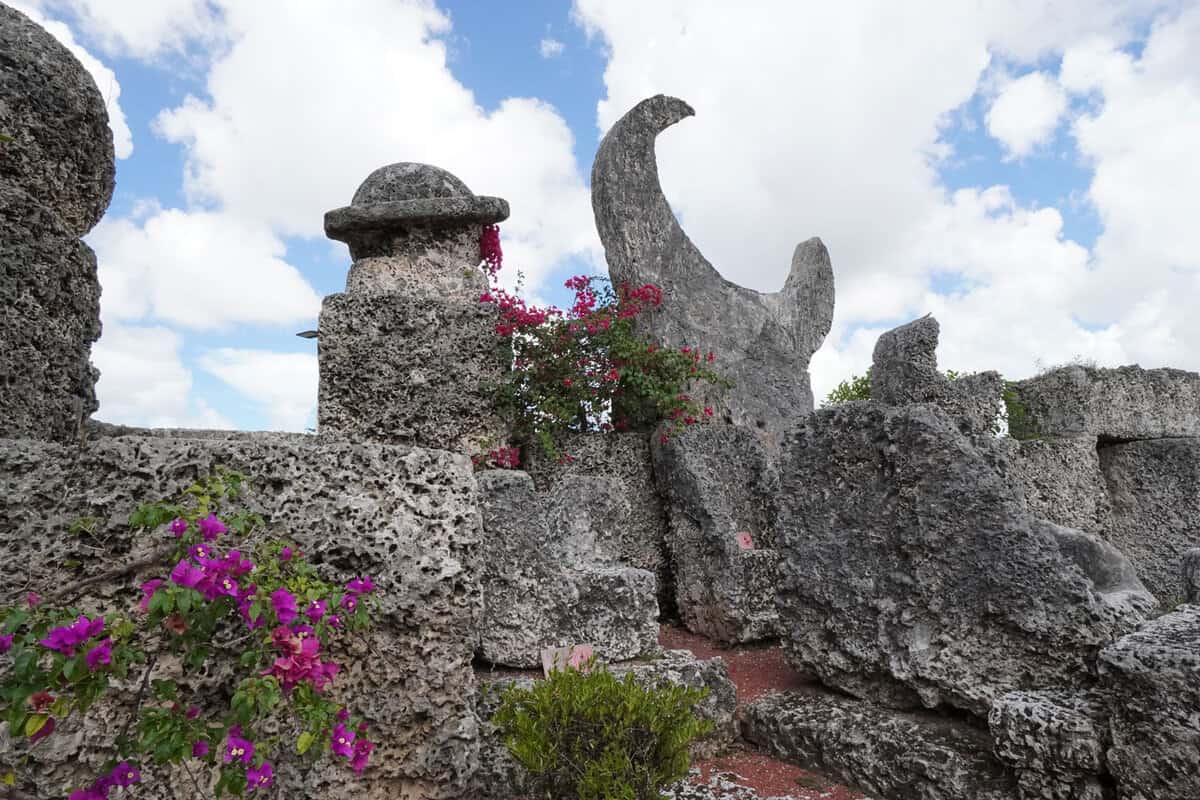 Tall rock structures with a crescent moon shaped rock at Coral Castle, Florida