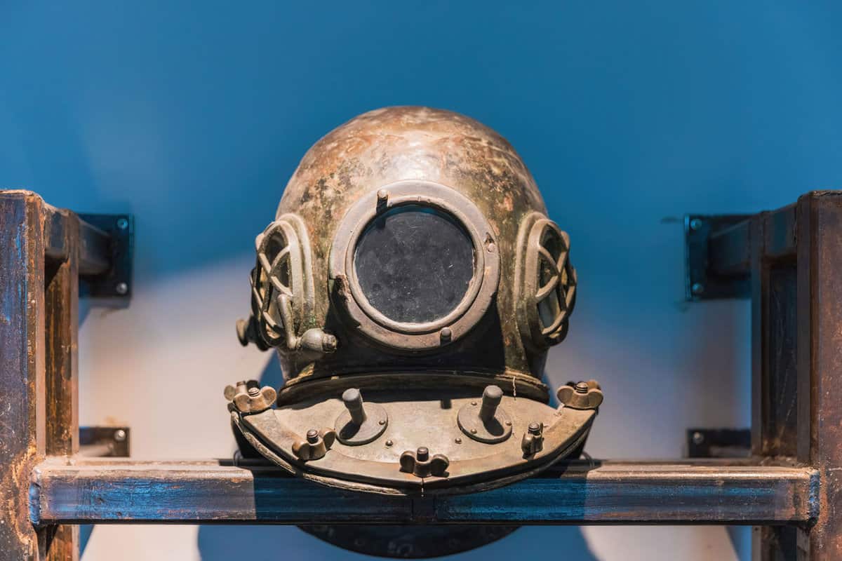 History of Diving Museum, A Group of Old metal diving helmet, dusted in room