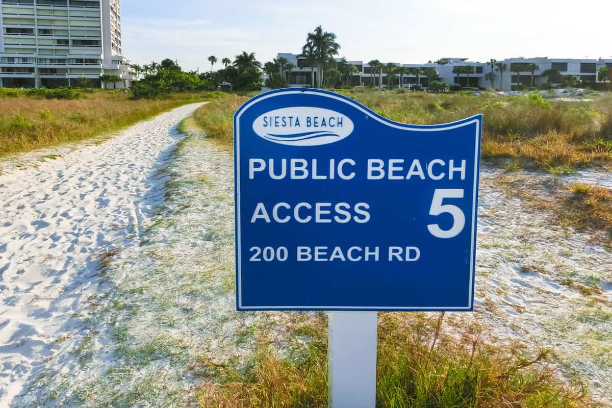 Siesta Key welcome sign with beach road
