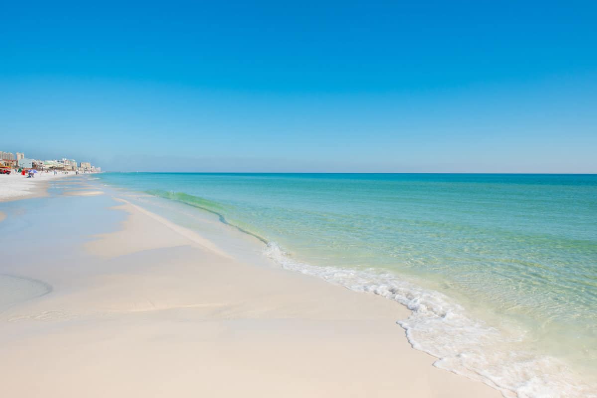 coastline with blue sky and blue green water emerald coast florida