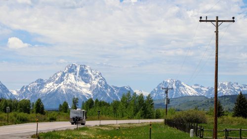 RV traveling along the open road outside of Jackson Hole, 9 Best RV Parks Near Yellowstone For a Memorable Road Trip - 1600x900