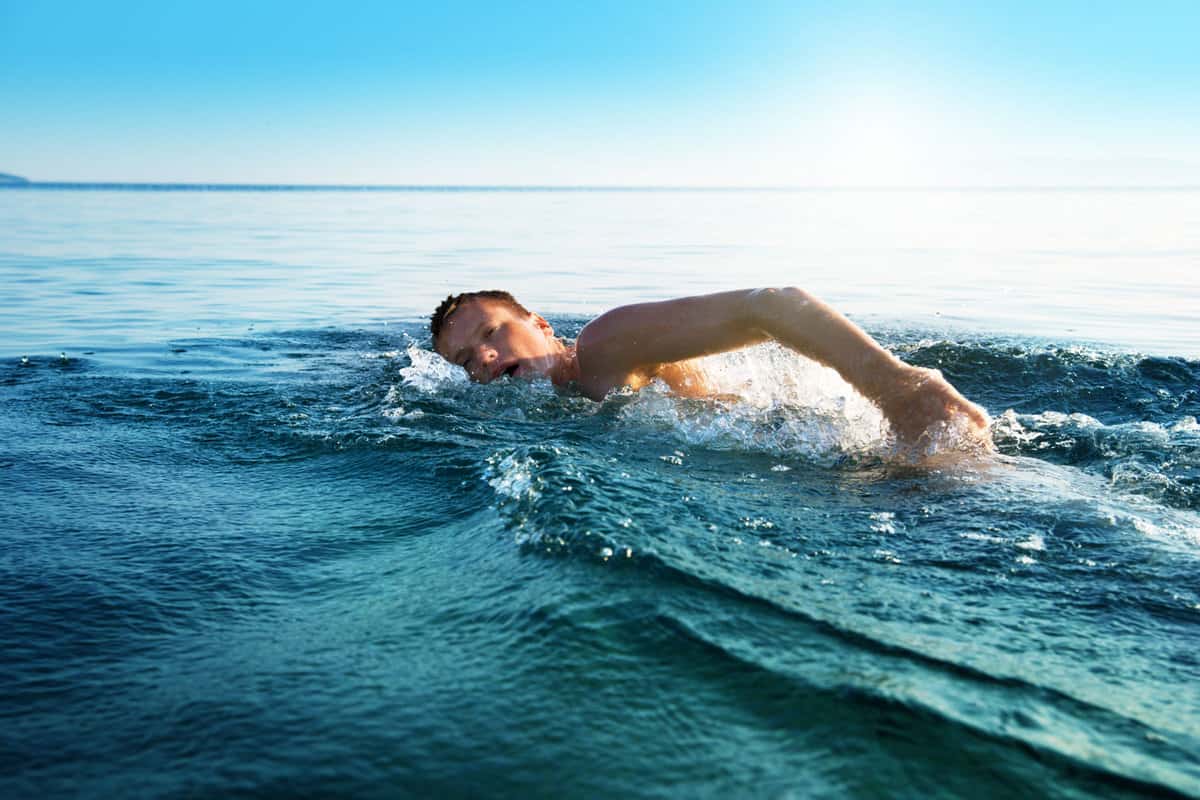 A man swimming in the waters of Sanibel Island