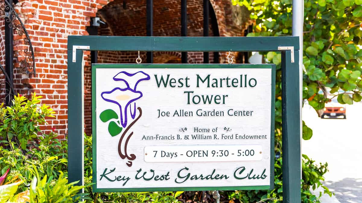 Brick fortress wall and plants flowers in Martello Botanical Joe Allen Garden Center with sign