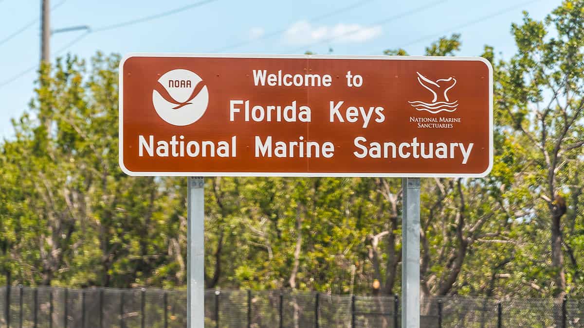 Florida Keys sign for welcome to national marine sanctuary or noaa on overseas highway road1600x900