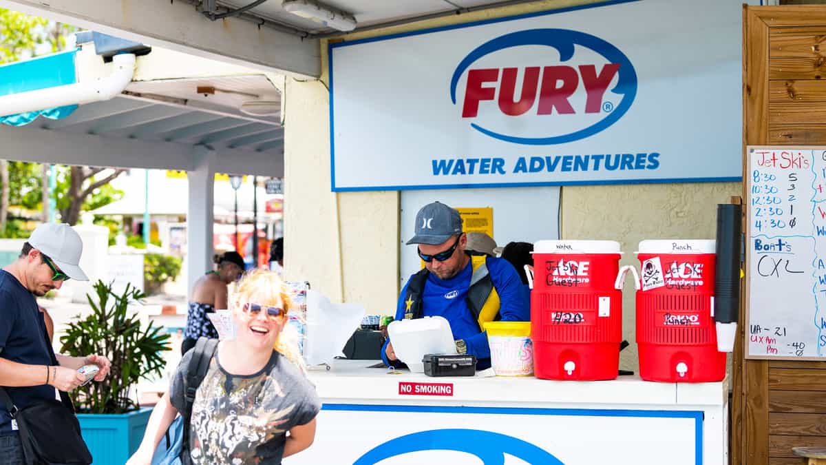 Fury water adventures jet ski tour, guided tour office, rental, snorkeling, boat cruise, bikes, parasail at store, shop in Florida keys island, people, salesperson