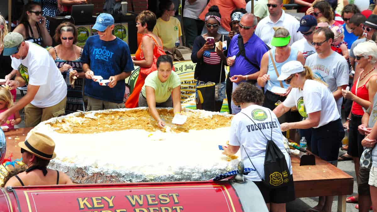 Pieces of the largest Key Lime pie in the world are handed out to tourists and locals alike on July, in Key West, Florida, at the first annual Key Lime Pie Festival.