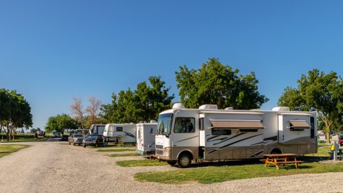 Rv campers at campsites on a sunny morning with blue skies 1600x900
