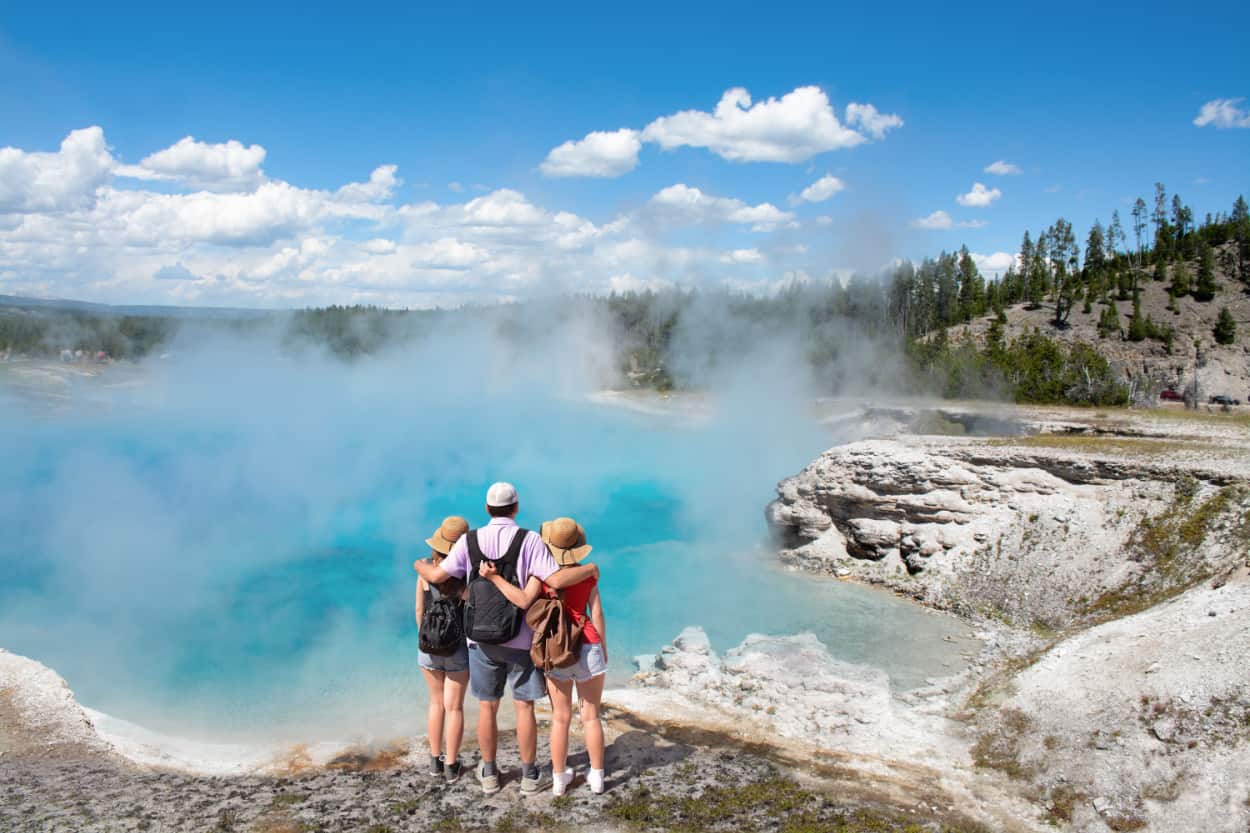 Family relaxing and enjoying beautiful view of geyser