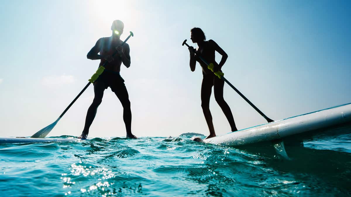 Stand up paddle board couple paddleboarding