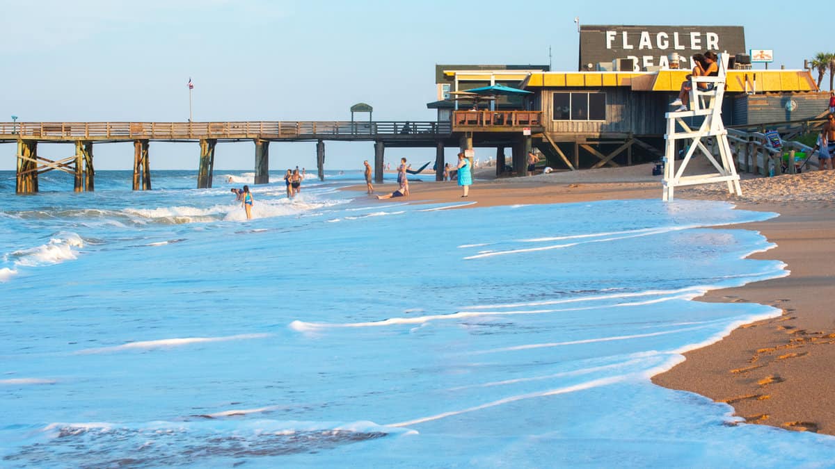 Visitors enjoy a sparsely populated evening on Flagler Beach as the sun begins to set