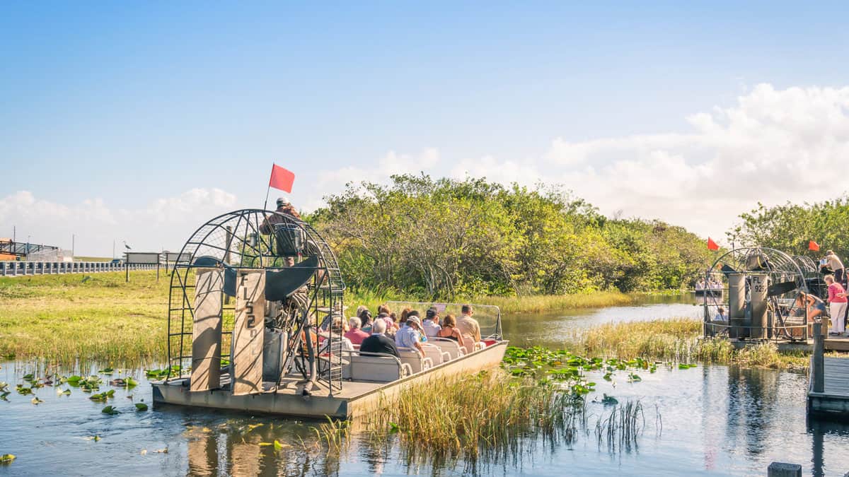 group of international tourists leaving from the airboat pier in everglades national park