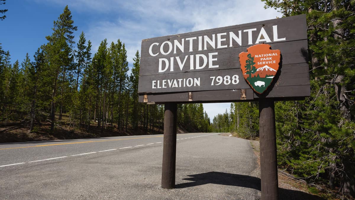 The Continental Divide sign with an elevation indicator at the bottom, The Continental Divide in Yellowstone: Where Waters Part Ways - 1600x900